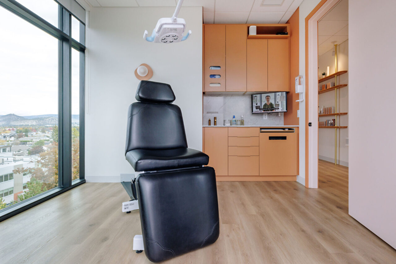 Dr Ben Wiese office interior in Kelowna, BC, showing a medical chair in a treatment room with cabinets and a view overlooking Kelowna