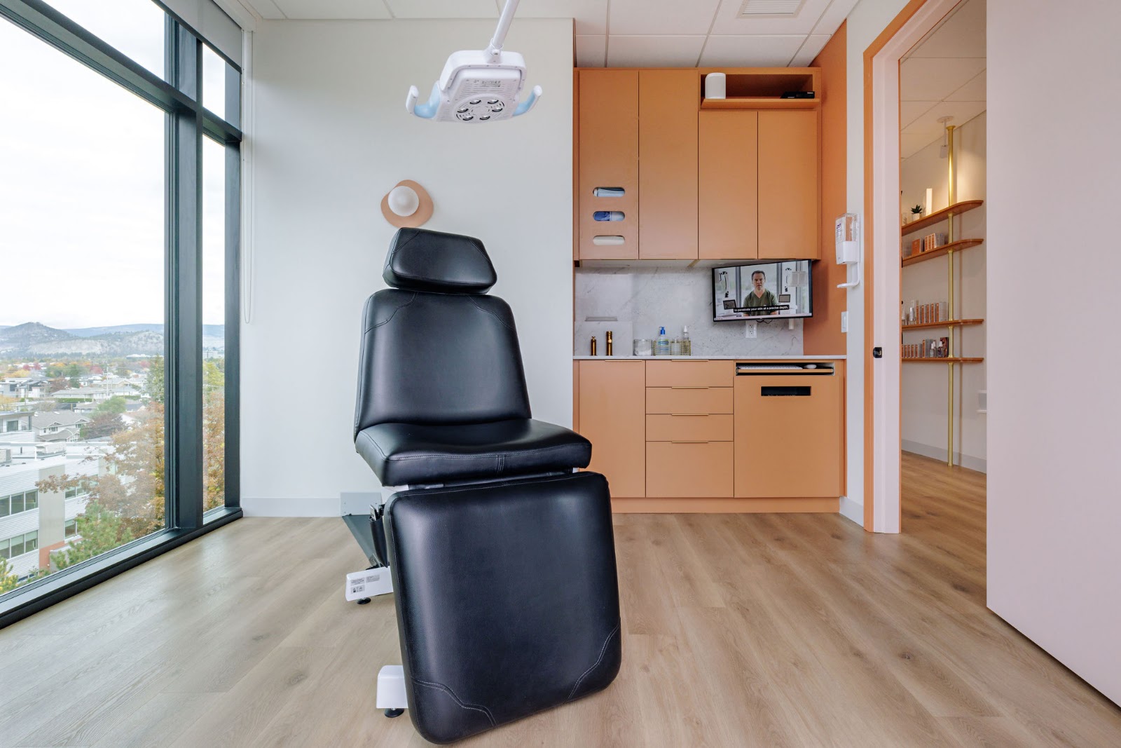 an empty treatment room chair at Dr Ben Wiese's private skin cancer clinic, with a view of Kelowna outside the window