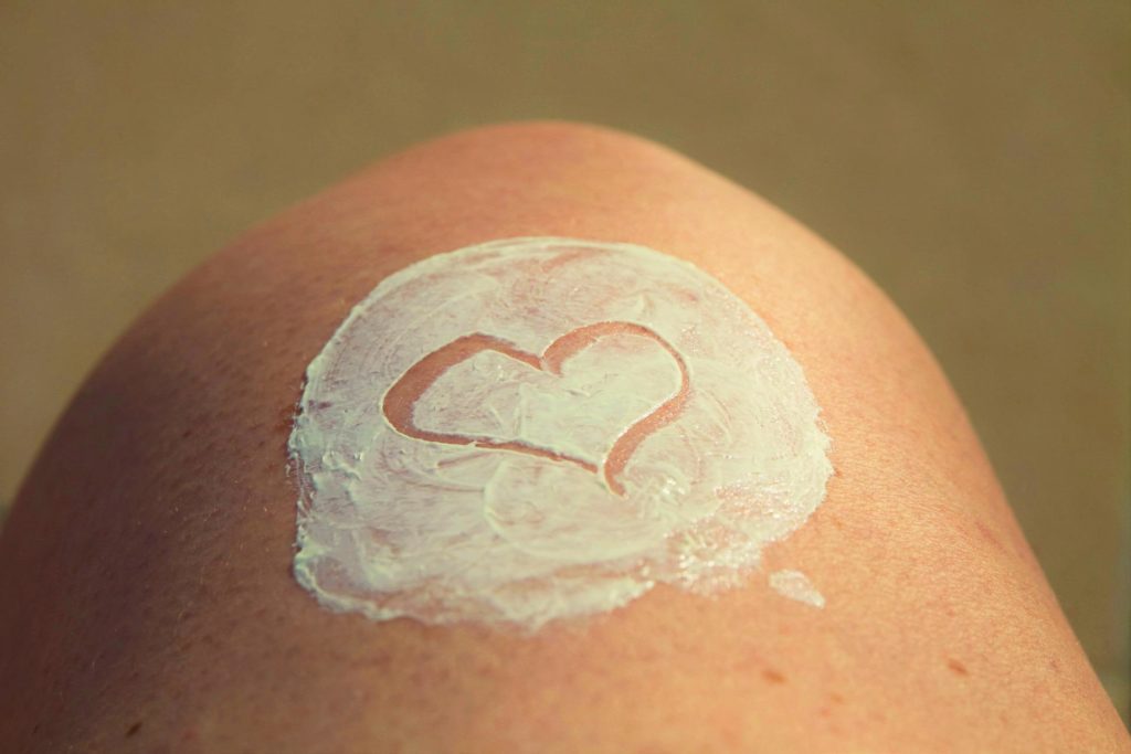 Patch of sunscreen with a heart drawn on it, on someones knee.